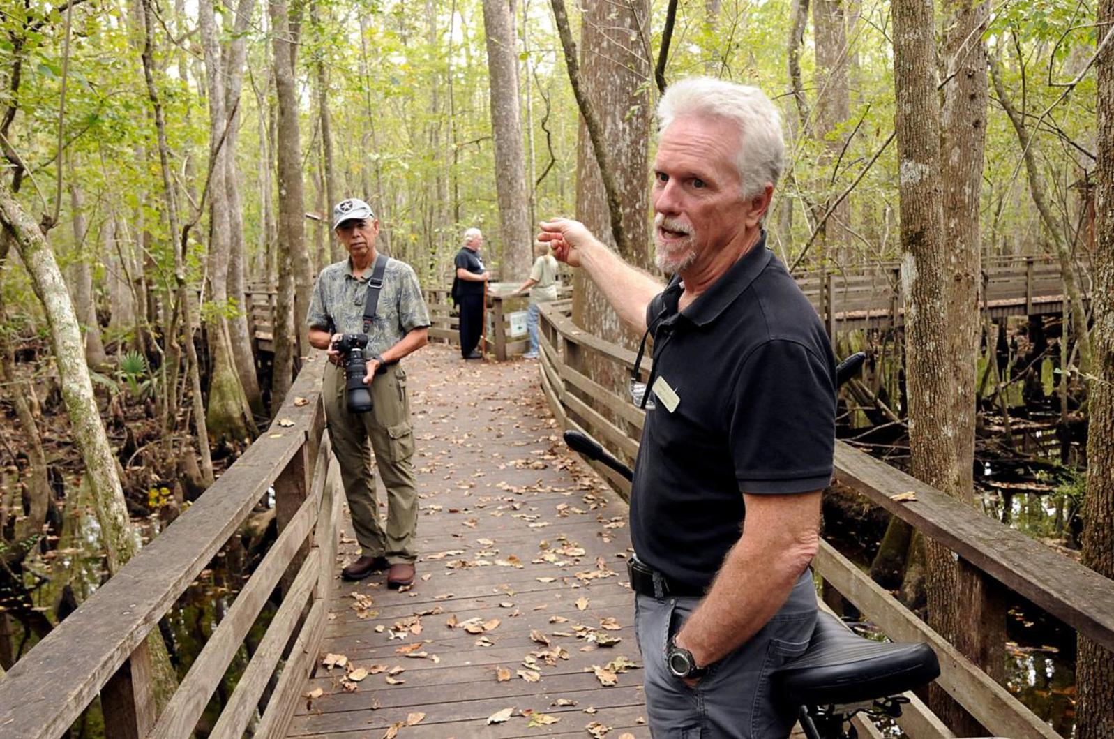 Mike Dawson answers questions from visitors on the Beidler Forest boardwalk 