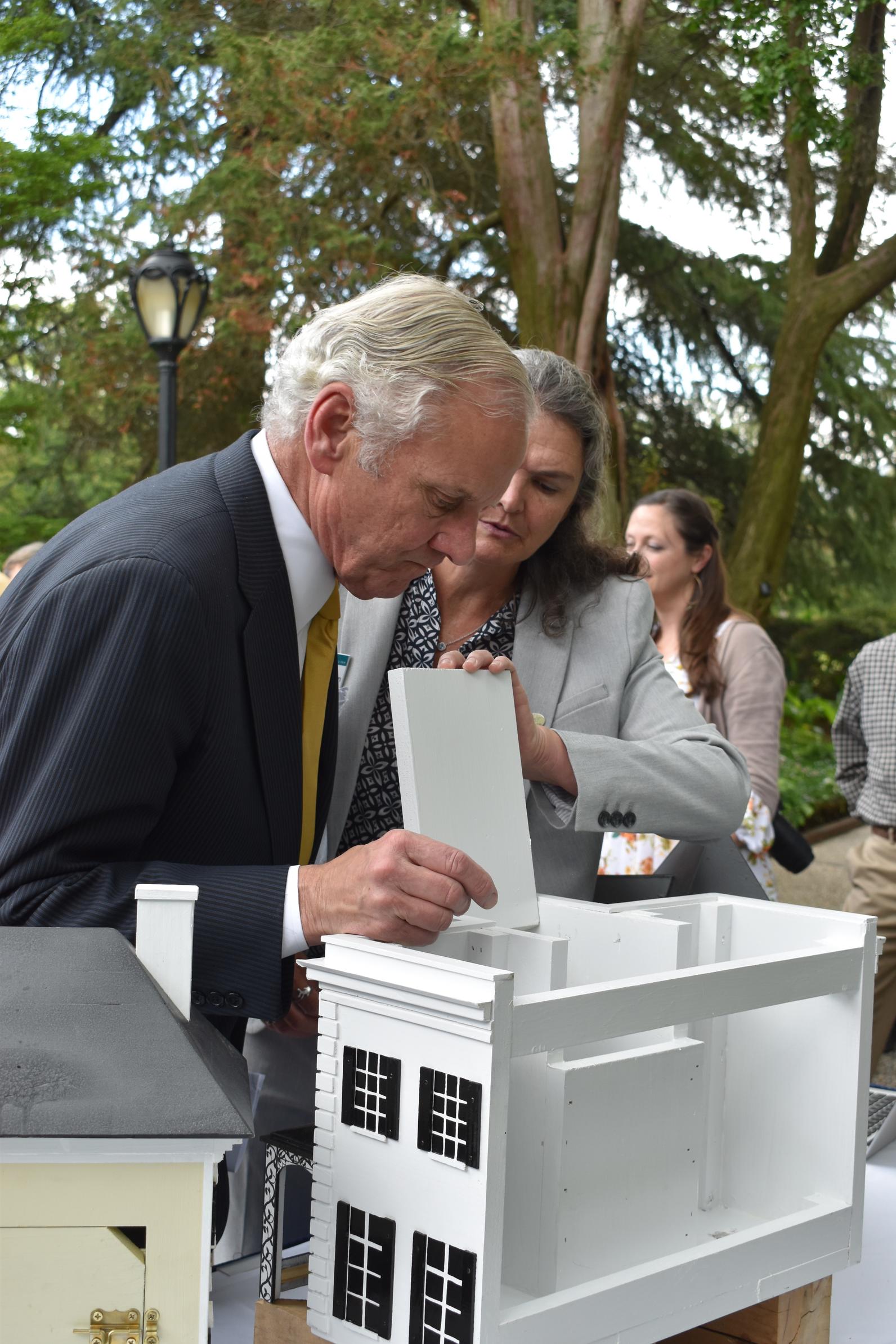 Sharon Richardson shows Gov. McMaster the handcrafted, mansion replica birdhouses