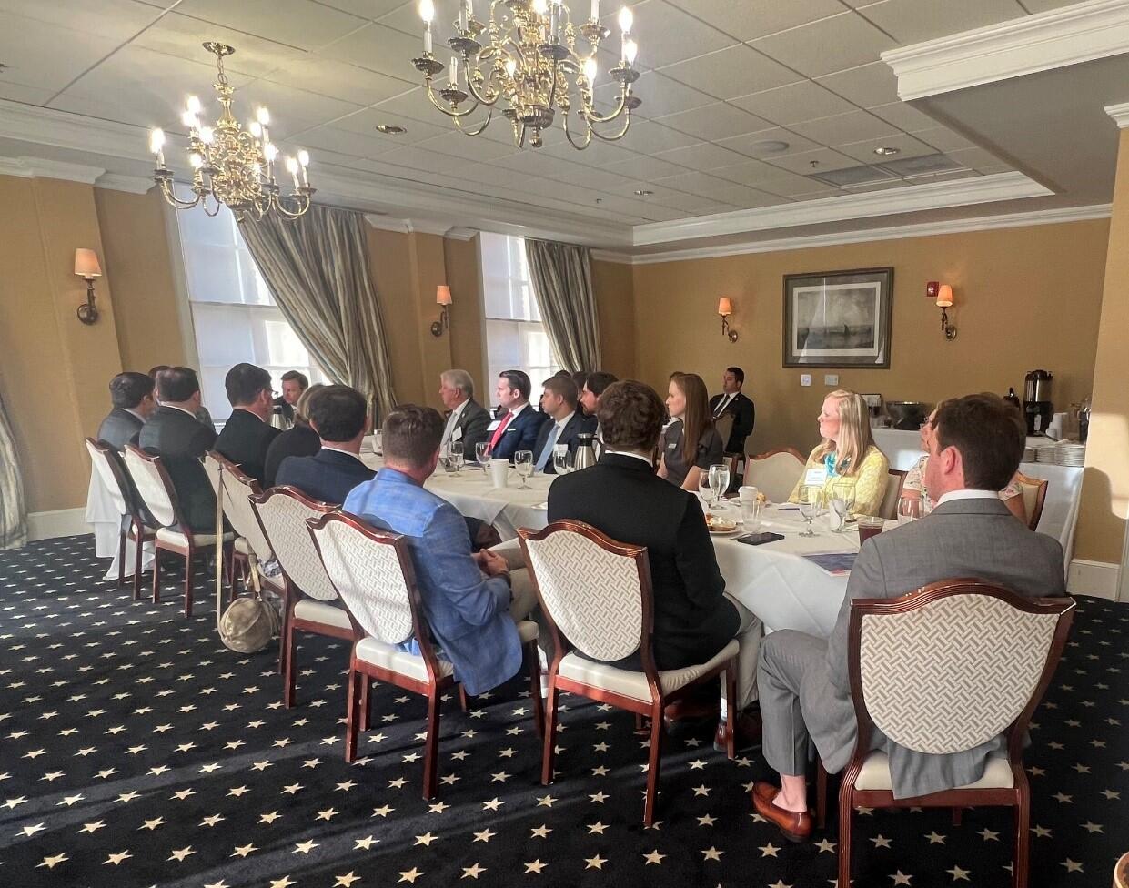 People in suits sitting around a table